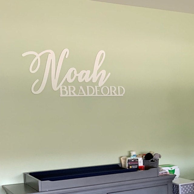 Noah Bradford two line name sign on wall