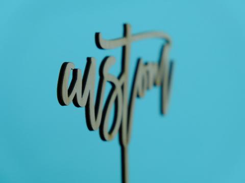 profile shot of wood cake topper