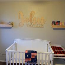 John Taylor two line sign on wall